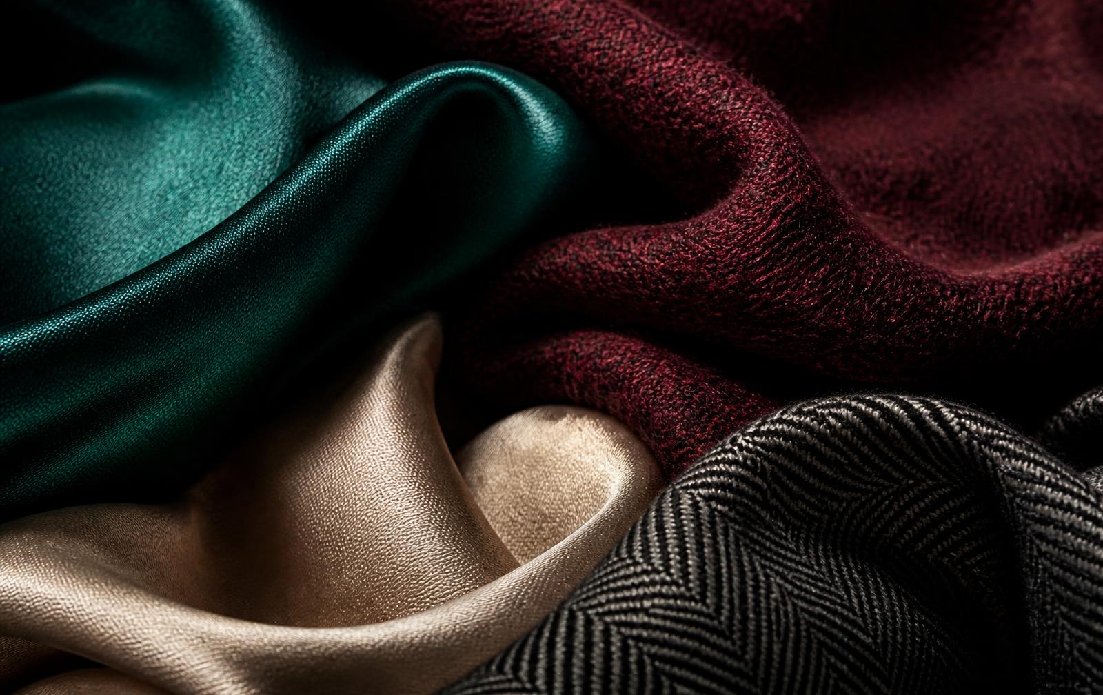 Emerald, burgundy, champagne and charcoal fabrics layered